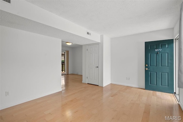 9177 Robin Ct, Brentwood, MO 63144 - unfurnished room with light wood finished floors, a textured ceiling, and baseboards