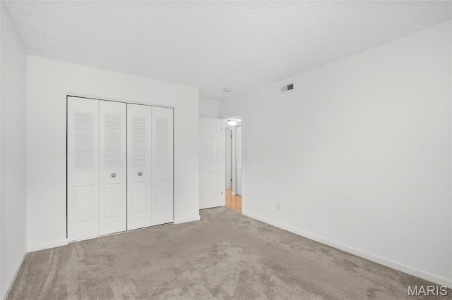 9177 Robin Ct, Brentwood, MO 63144 - unfurnished bedroom with carpet floors, a closet, baseboards, and a textured ceiling