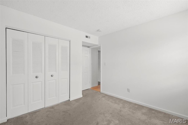 9177 Robin Ct, Brentwood, MO 63144 - unfurnished bedroom featuring carpet floors, a closet, baseboards, and a textured ceiling