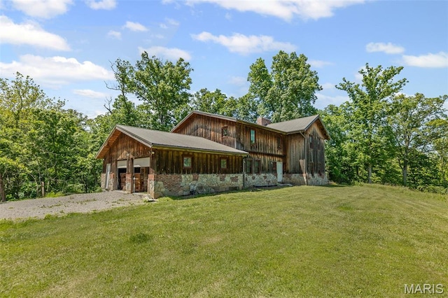 5423 Saxtown Rd, Millstadt, IL 62260 - chalet / cabin featuring a chimney, an attached garage, a front lawn, and board and batten siding