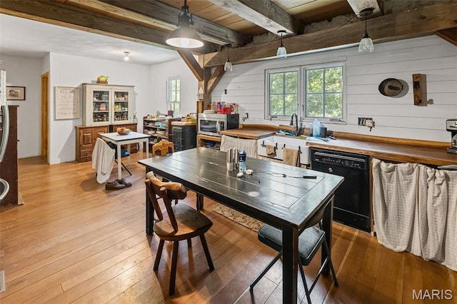 5423 Saxtown Rd, Millstadt, IL 62260 - kitchen featuring black dishwasher, beamed ceiling, plenty of natural light, light wood finished floors, and wooden walls