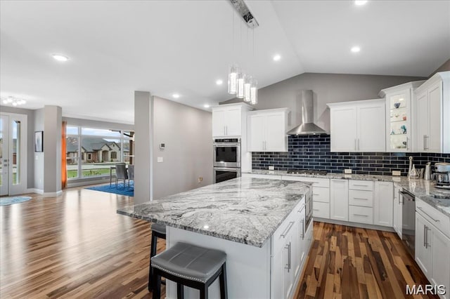 1547 Frost Lndg, Columbia, IL 62236 - kitchen with wall chimney range hood, appliances with stainless steel finishes, dark wood finished floors, a center island, and vaulted ceiling