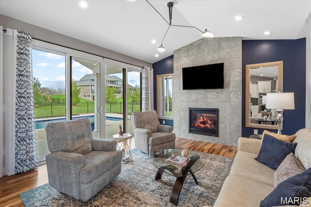 1547 Frost Lndg, Columbia, IL 62236 - living area with wood finished floors, vaulted ceiling, a tile fireplace, and recessed lighting