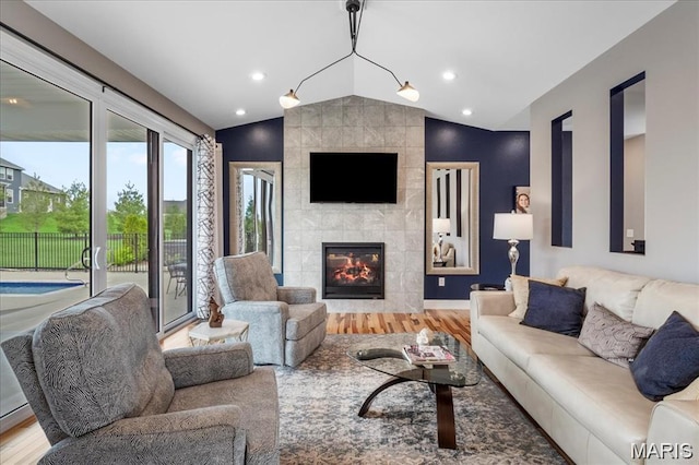 1547 Frost Lndg, Columbia, IL 62236 - living area featuring vaulted ceiling, wood finished floors, a tiled fireplace, and recessed lighting