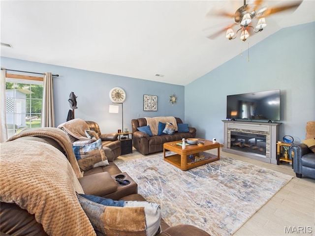 4862 State Highway 142e, Doniphan, MO 63935 - living area with vaulted ceiling, a ceiling fan, a stone fireplace, and wood finished floors