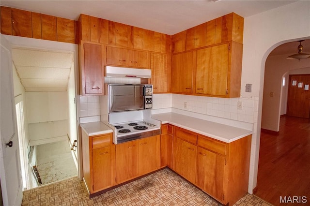 703 Condit Ave, Alton, IL 62002 - kitchen with under cabinet range hood, light countertops, arched walkways, and backsplash