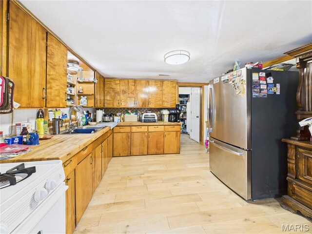 284 Wayne 349, Piedmont, MO 63957 - kitchen with freestanding refrigerator, white gas range oven, a sink, brown cabinets, and open shelves