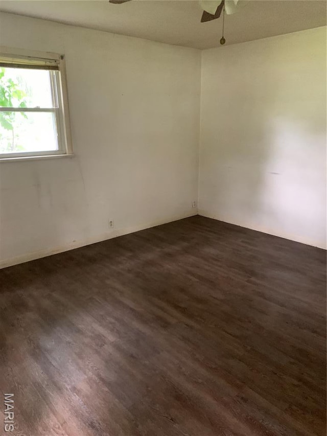 215 Berry St, Gillespie, IL 62033 - empty room featuring a ceiling fan and dark wood finished floors