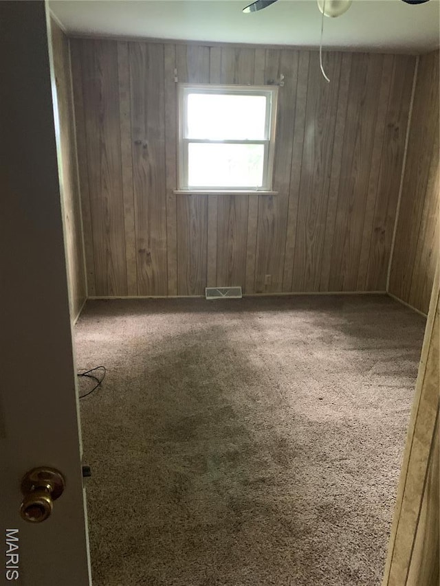 215 Berry St, Gillespie, IL 62033 - carpeted spare room featuring wooden walls and a ceiling fan