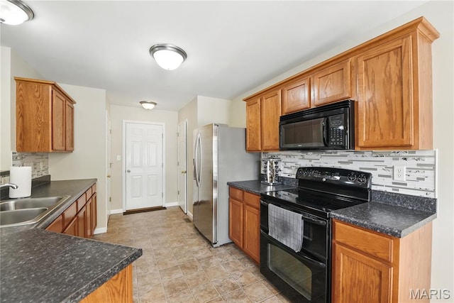 457 Spring Trce, Ofallon, MO 63368 - kitchen featuring black appliances, decorative backsplash, dark countertops, and brown cabinetry