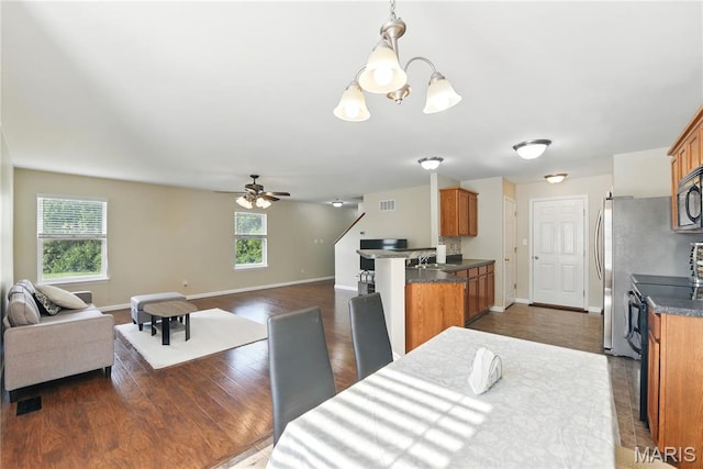 457 Spring Trce, Ofallon, MO 63368 - dining space with healthy amount of natural light, ceiling fan, a chandelier, and dark wood finished floors