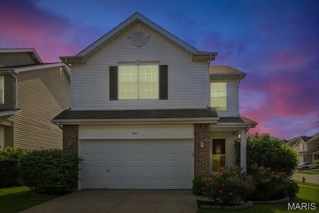 457 Spring Trce, Ofallon, MO 63368 - traditional home featuring an attached garage, driveway, and brick siding