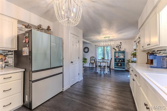 20193 SW Oakwood Dr, Lebanon, MO 65536 - kitchen featuring a chandelier, freestanding refrigerator, light countertops, and white cabinets