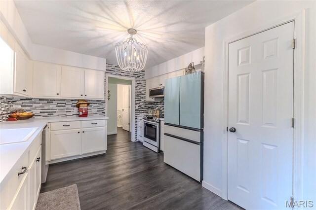 20193 SW Oakwood Dr, Lebanon, MO 65536 - kitchen with appliances with stainless steel finishes, a chandelier, tasteful backsplash, and white cabinetry