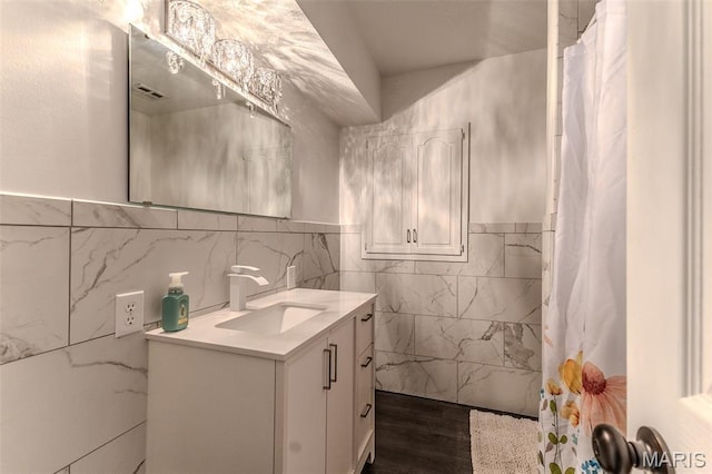 20193 SW Oakwood Dr, Lebanon, MO 65536 - bathroom featuring tile walls, vanity, wood finished floors, curtained shower, and a wainscoted wall
