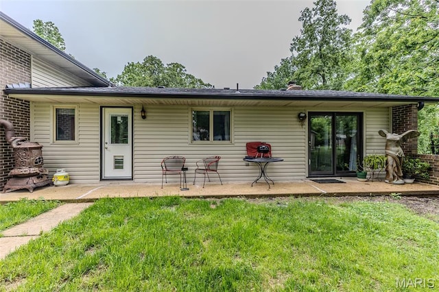 20193 SW Oakwood Dr, Lebanon, MO 65536 - back of house featuring a yard, a patio area, and a chimney