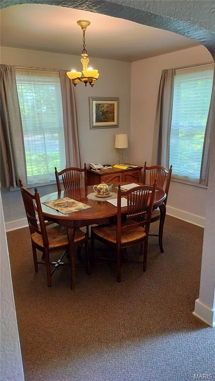 1500 Perryville Rd, Cape Girardeau, MO 63701 - dining area featuring baseboards, a chandelier, and dark carpet