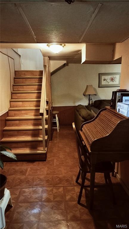 1500 Perryville Rd, Cape Girardeau, MO 63701 - basement featuring wood walls, a wainscoted wall, and stairs