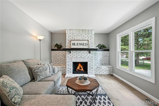 208 Mill Run Ln, Saint Peters, MO 63376 - living room featuring wood finished floors and a brick fireplace