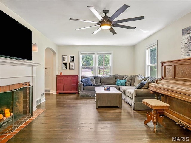 201 Banner St, Edwardsville, IL 62025 - living room featuring arched walkways, plenty of natural light, ceiling fan, and dark wood-type flooring
