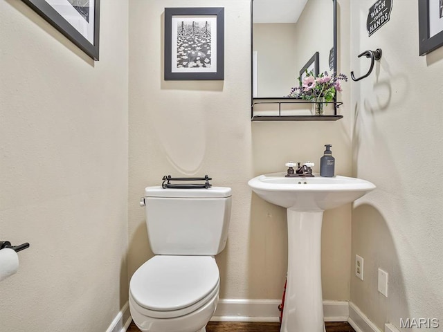 201 Banner St, Edwardsville, IL 62025 - bathroom featuring toilet, a sink, and baseboards