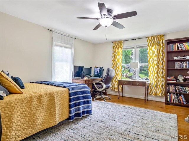201 Banner St, Edwardsville, IL 62025 - bedroom featuring wood finished floors, an office area, baseboards, and a ceiling fan