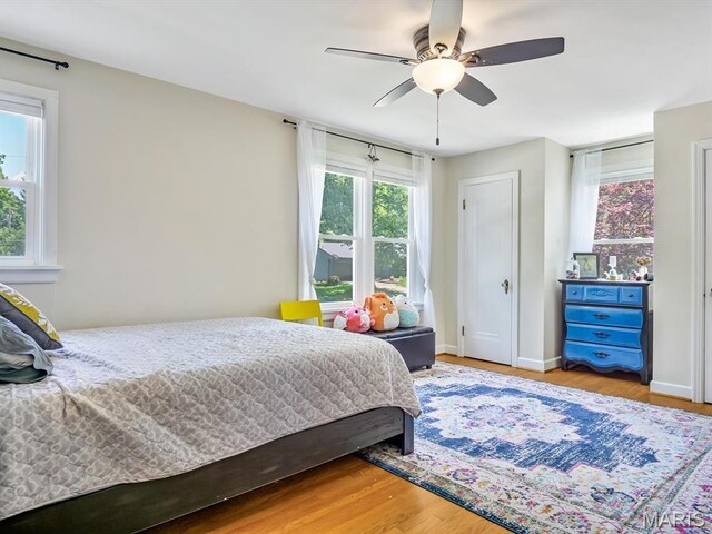 201 Banner St, Edwardsville, IL 62025 - bedroom with multiple windows, wood finished floors, ceiling fan, and baseboards