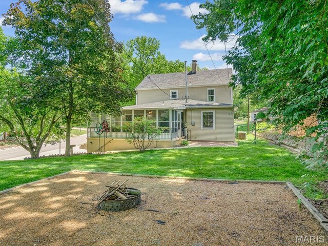 201 Banner St, Edwardsville, IL 62025 - back of house with a sunroom, an outdoor fire pit, and a chimney