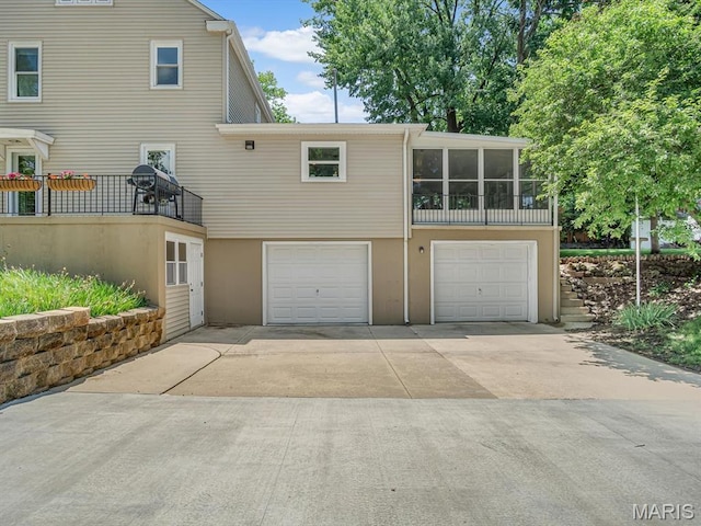 201 Banner St, Edwardsville, IL 62025 - rear view of house with a garage, driveway, and stucco siding