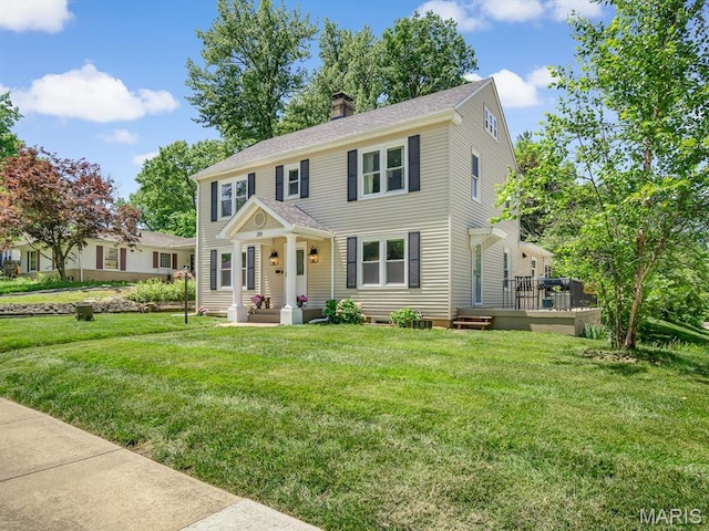 201 Banner St, Edwardsville, IL 62025 - colonial inspired home featuring a chimney, a front lawn, and a deck