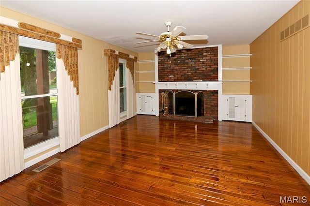 12713 Partridge Run Dr, Florissant, MO 63033 - unfurnished living room featuring hardwood / wood-style flooring, a ceiling fan, a brick fireplace, and baseboards