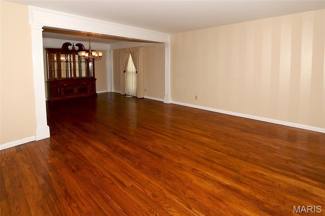 12713 Partridge Run Dr, Florissant, MO 63033 - empty room featuring a chandelier, wood finished floors, and baseboards