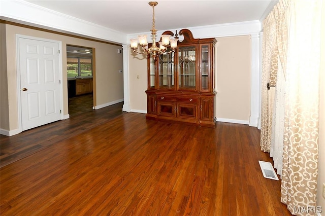 12713 Partridge Run Dr, Florissant, MO 63033 - unfurnished dining area featuring a chandelier, dark wood-style floors, baseboards, and crown molding