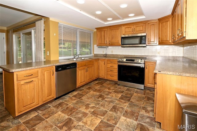 12713 Partridge Run Dr, Florissant, MO 63033 - kitchen with appliances with stainless steel finishes, a sink, decorative backsplash, stone finish floors, and a peninsula