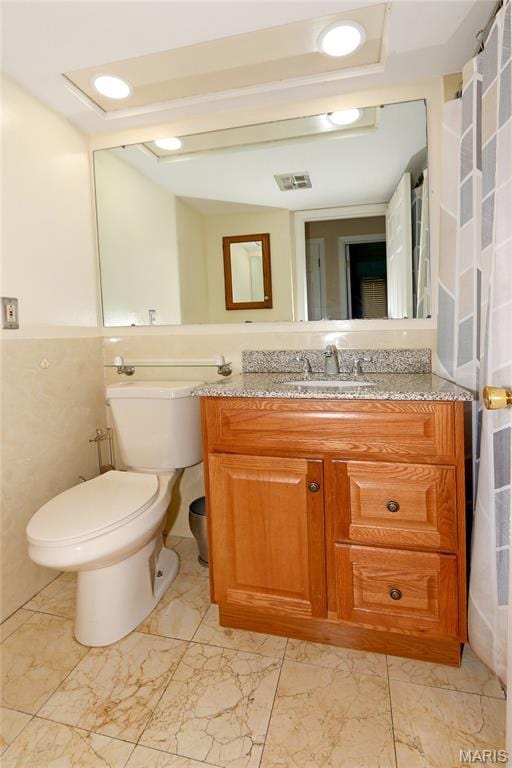 12713 Partridge Run Dr, Florissant, MO 63033 - bathroom with vanity, toilet, and marble look tile flooring