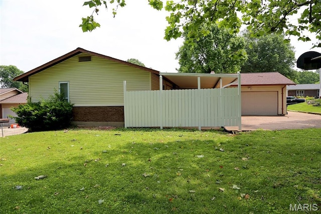 12713 Partridge Run Dr, Florissant, MO 63033 - view of home's exterior featuring driveway, a yard, a garage, and brick siding