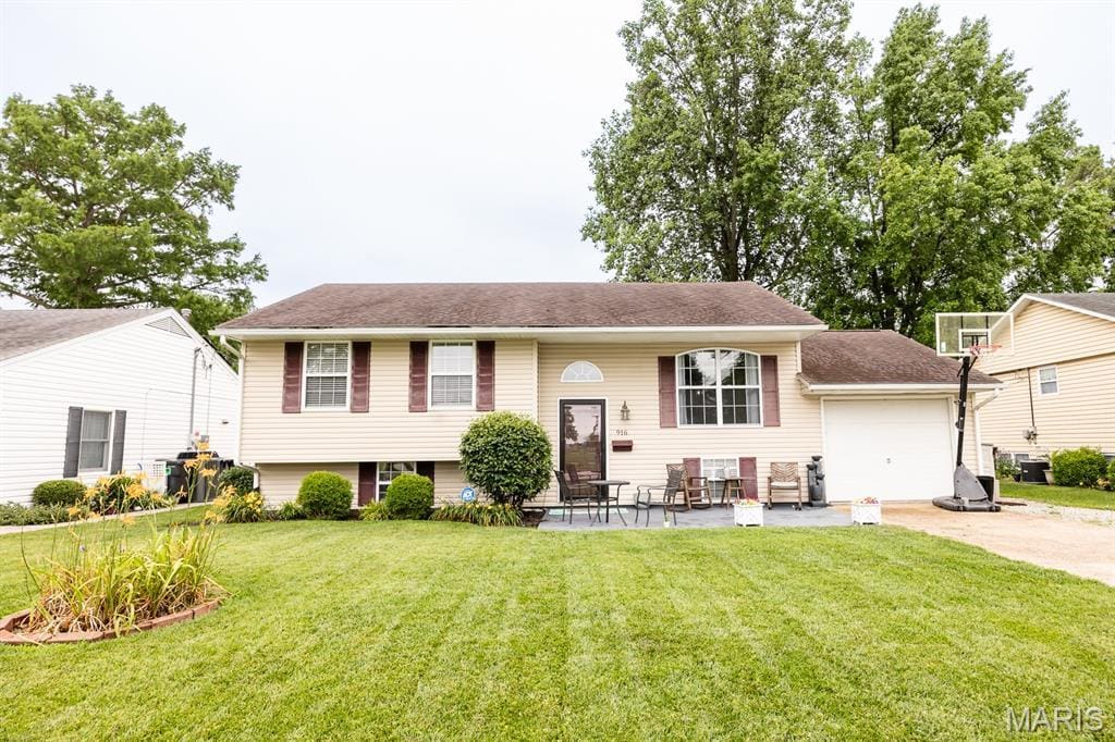 916 W Harnett St, Mascoutah, IL 62258 - raised ranch with driveway, a front yard, and a garage