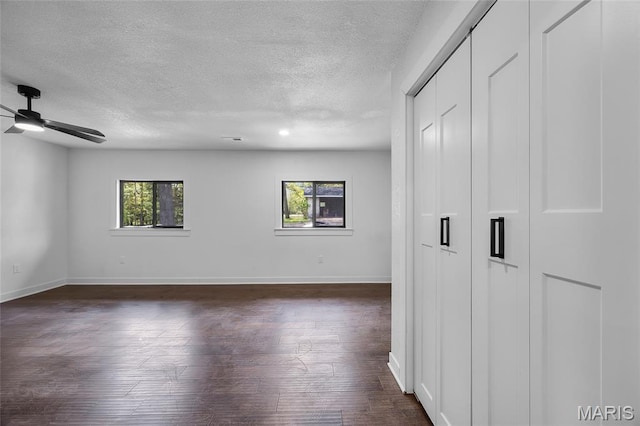 509 Saint Francois Rd, Bonne Terre, MO 63628 - empty room with a textured ceiling, dark wood-style flooring, a ceiling fan, and baseboards