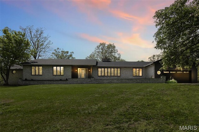 509 Saint Francois Rd, Bonne Terre, MO 63628 - view of front of house featuring an attached garage, a front yard, brick siding, and a chimney