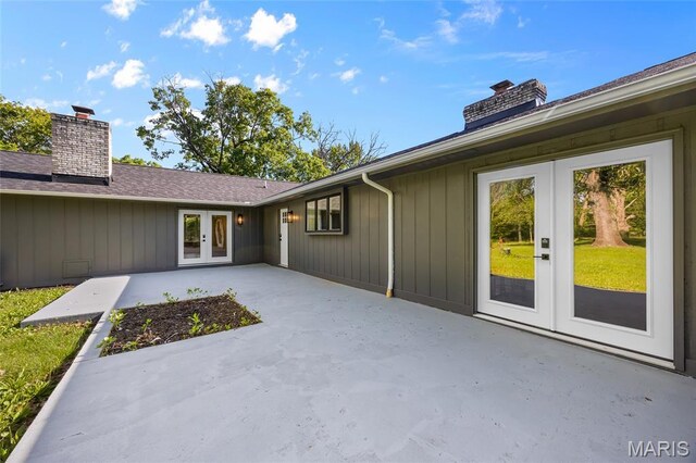 509 Saint Francois Rd, Bonne Terre, MO 63628 - property entrance with french doors, a chimney, a patio, and roof with shingles