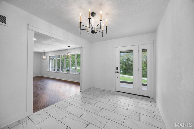 509 Saint Francois Rd, Bonne Terre, MO 63628 - entryway featuring a chandelier, marble look tile flooring, baseboards, and a textured ceiling