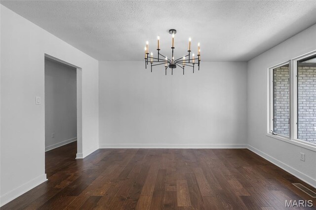 509 Saint Francois Rd, Bonne Terre, MO 63628 - unfurnished room with a chandelier, dark wood-type flooring, a textured ceiling, and baseboards