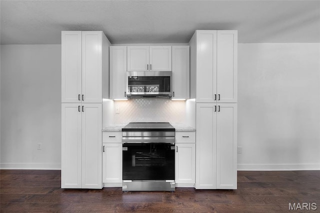 509 Saint Francois Rd, Bonne Terre, MO 63628 - kitchen with stainless steel appliances, baseboards, decorative backsplash, and white cabinetry