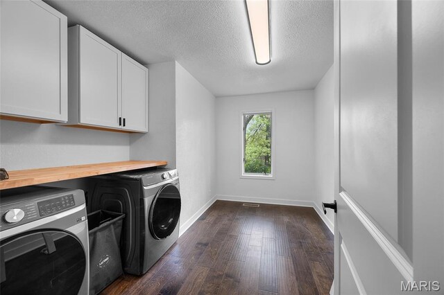 509 Saint Francois Rd, Bonne Terre, MO 63628 - laundry room with cabinet space, separate washer and dryer, a textured ceiling, dark wood finished floors, and baseboards