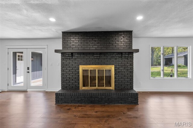 509 Saint Francois Rd, Bonne Terre, MO 63628 - unfurnished living room with a textured ceiling, wood finished floors, baseboards, recessed lighting, and a brick fireplace