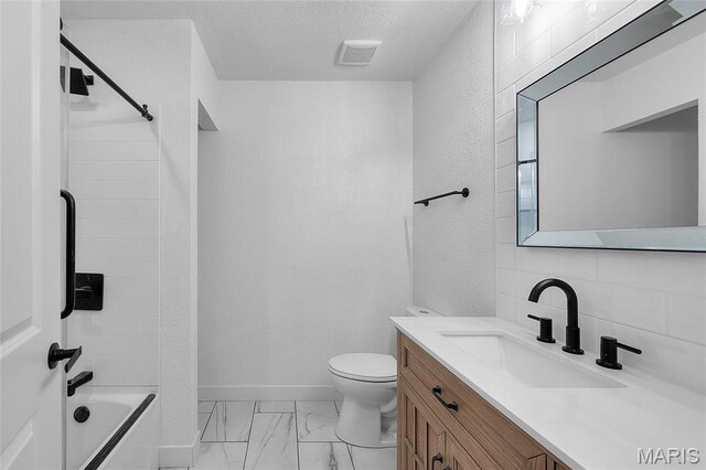 509 Saint Francois Rd, Bonne Terre, MO 63628 - full bath featuring vanity, marble look tile flooring, toilet, bathtub / shower combination, and a textured ceiling
