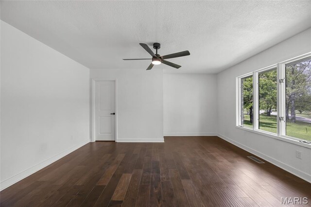 509 Saint Francois Rd, Bonne Terre, MO 63628 - spare room featuring dark wood-style floors, ceiling fan, baseboards, and a textured ceiling