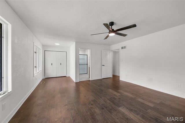 509 Saint Francois Rd, Bonne Terre, MO 63628 - unfurnished bedroom with wood finished floors, baseboards, a textured ceiling, ceiling fan, and ensuite bathroom