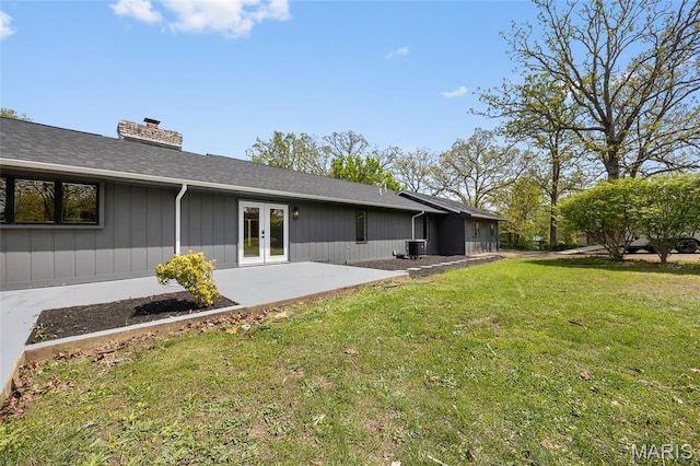 509 Saint Francois Rd, Bonne Terre, MO 63628 - rear view of house featuring french doors, a chimney, a lawn, a patio, and central air condition unit