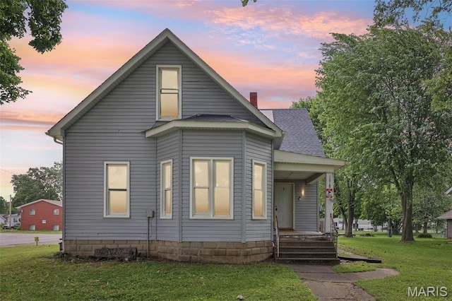 1618 N State St, Litchfield, IL 62056 - view of front of house featuring covered porch, a yard, and roof with shingles